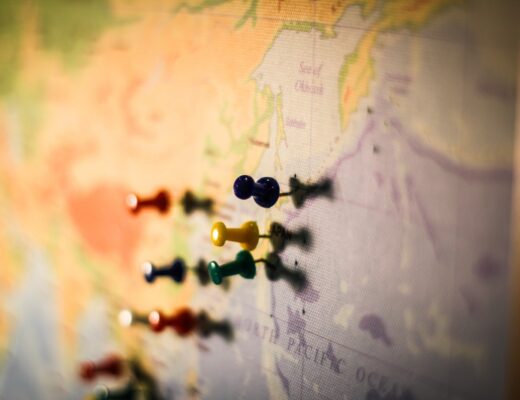 selective focus photography of push pin in map